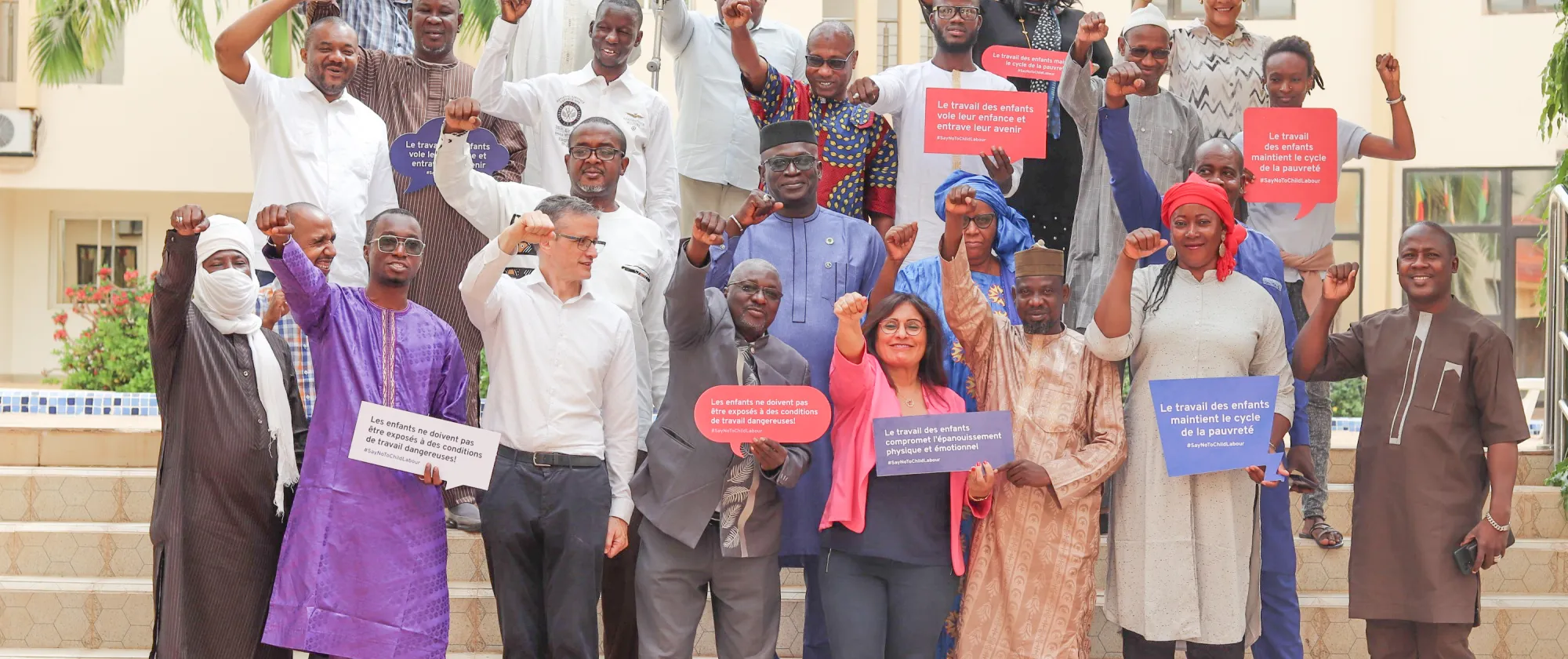 Participants to the event pose for a picture raising their hands 
