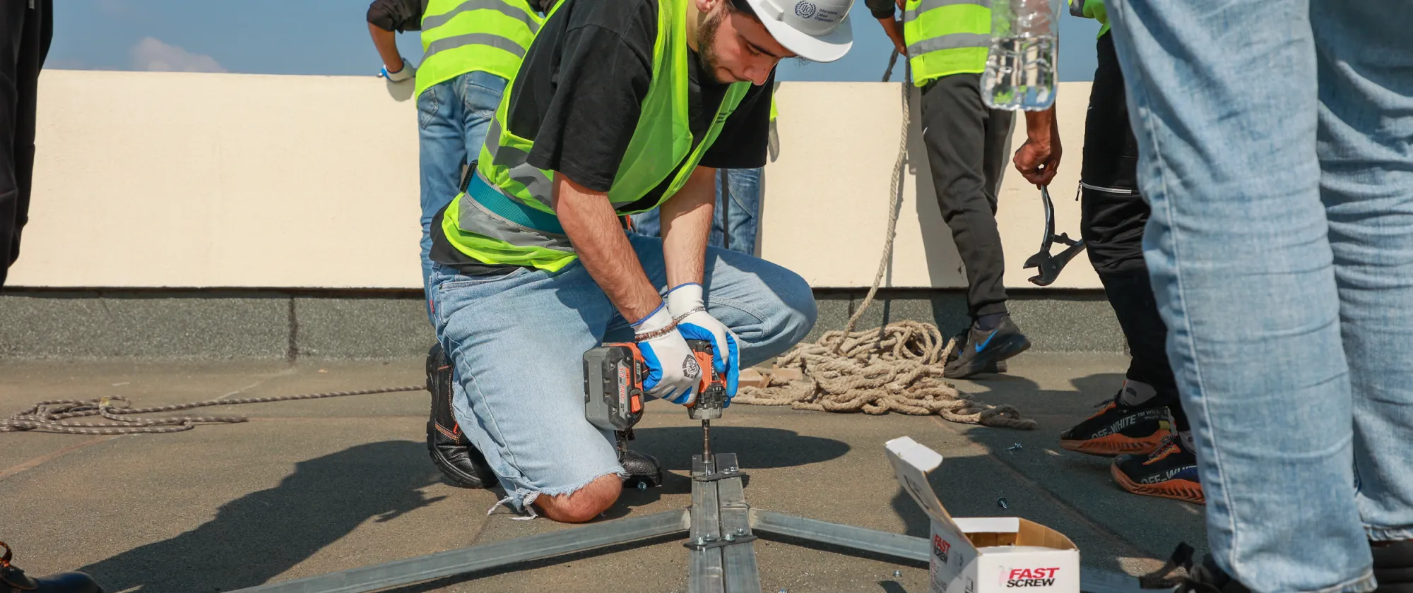 workers installing solar panels on a roof