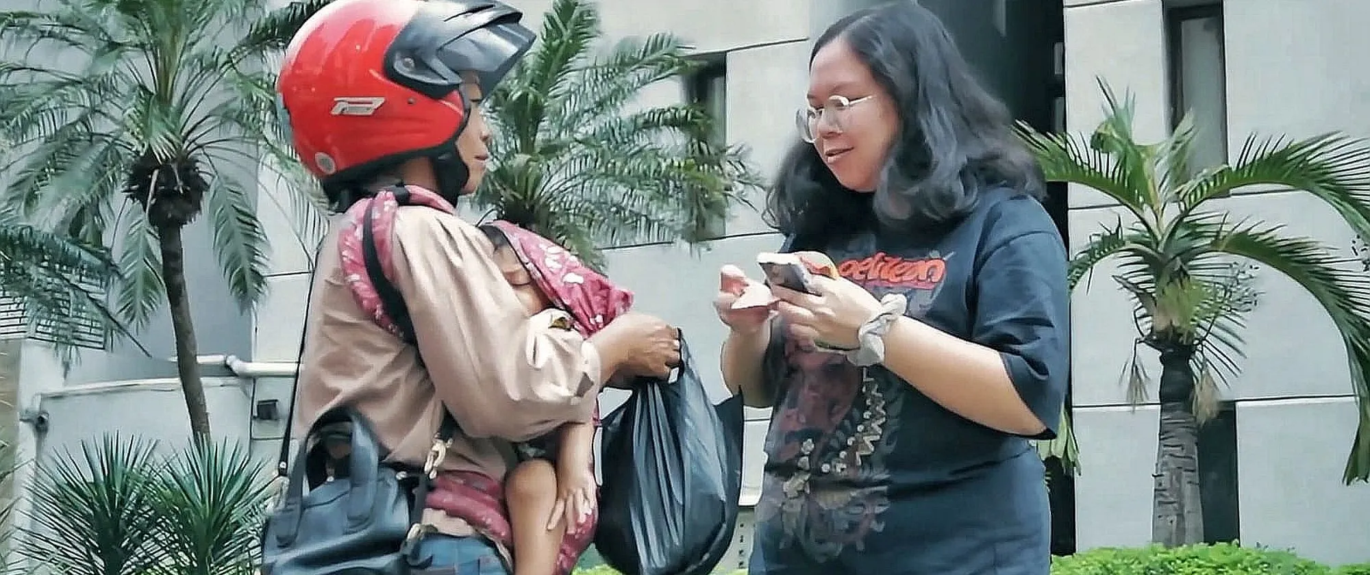 Natalia brings her baby to work as a food delivery. 