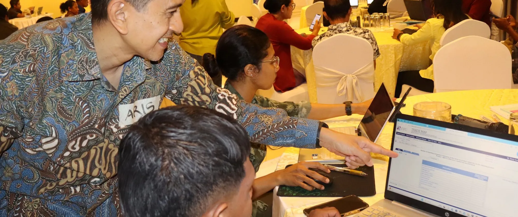 Participants actively engage in a hands-on session, exploring the Global Trade web platform to enhance their understanding and access to international trade resources.