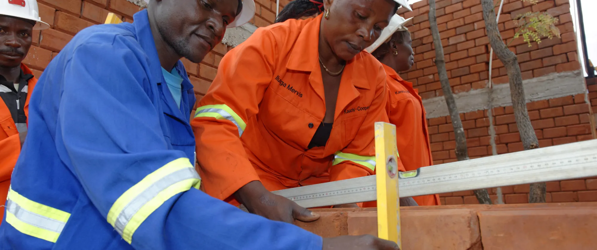 Man and woman building a house made of bricks 