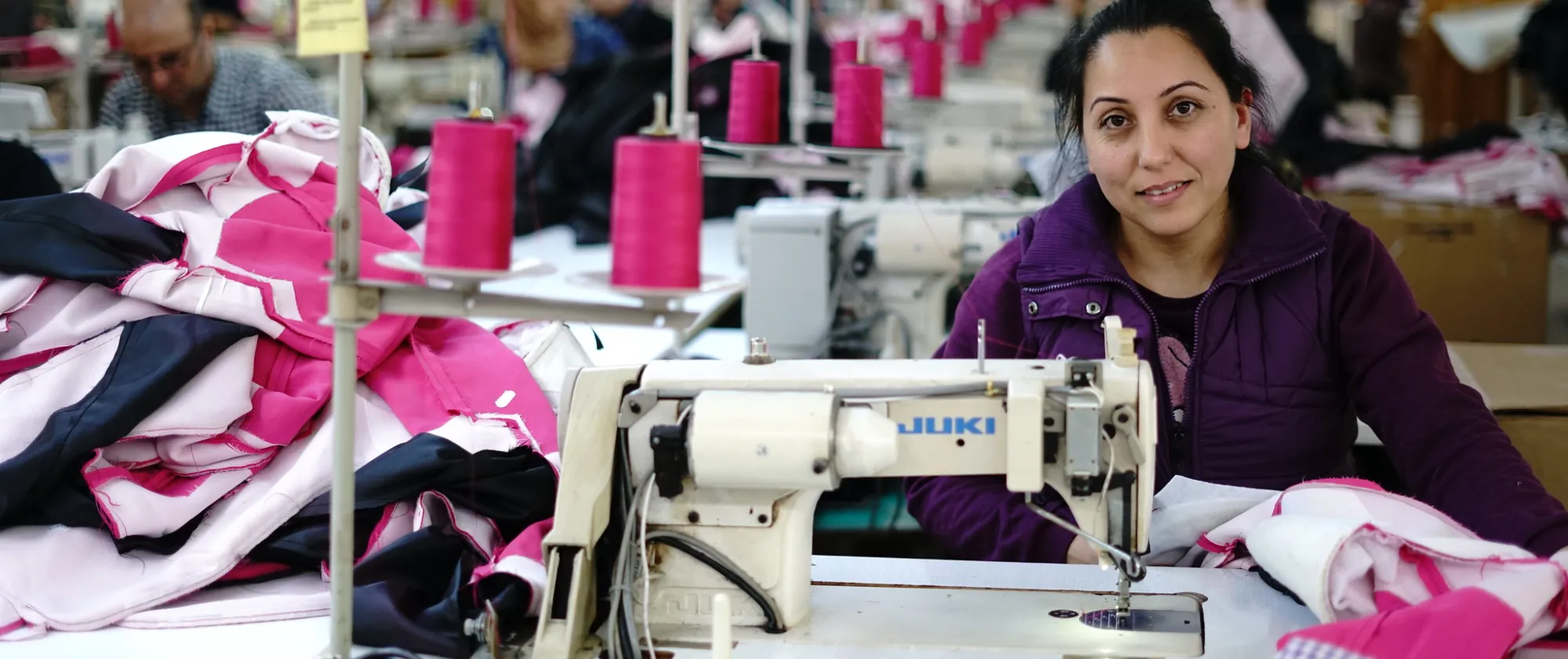 Syrian refugee learning skills in the garment sector