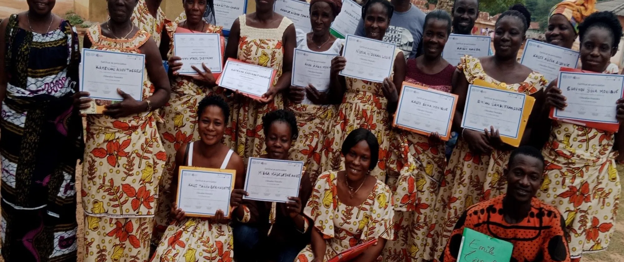 Farmers pose for a group picture with certificates in their hands