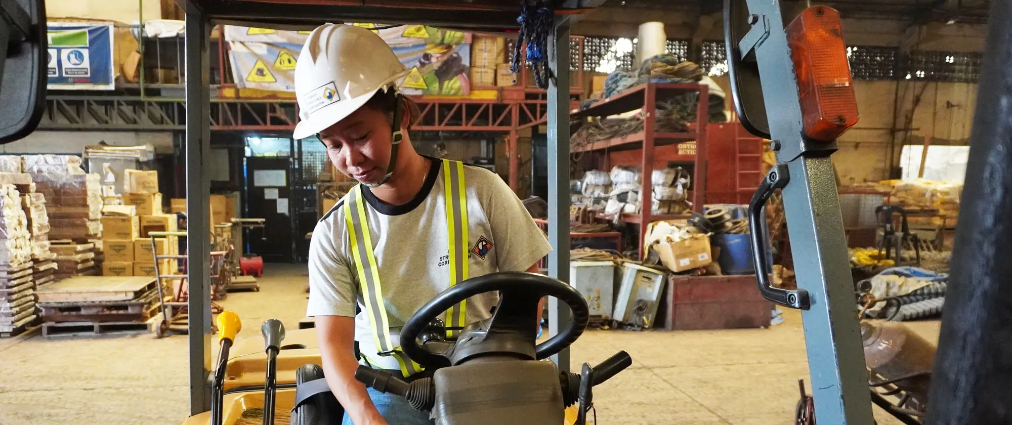 female construction supervisor operates a forklift in Cebu
