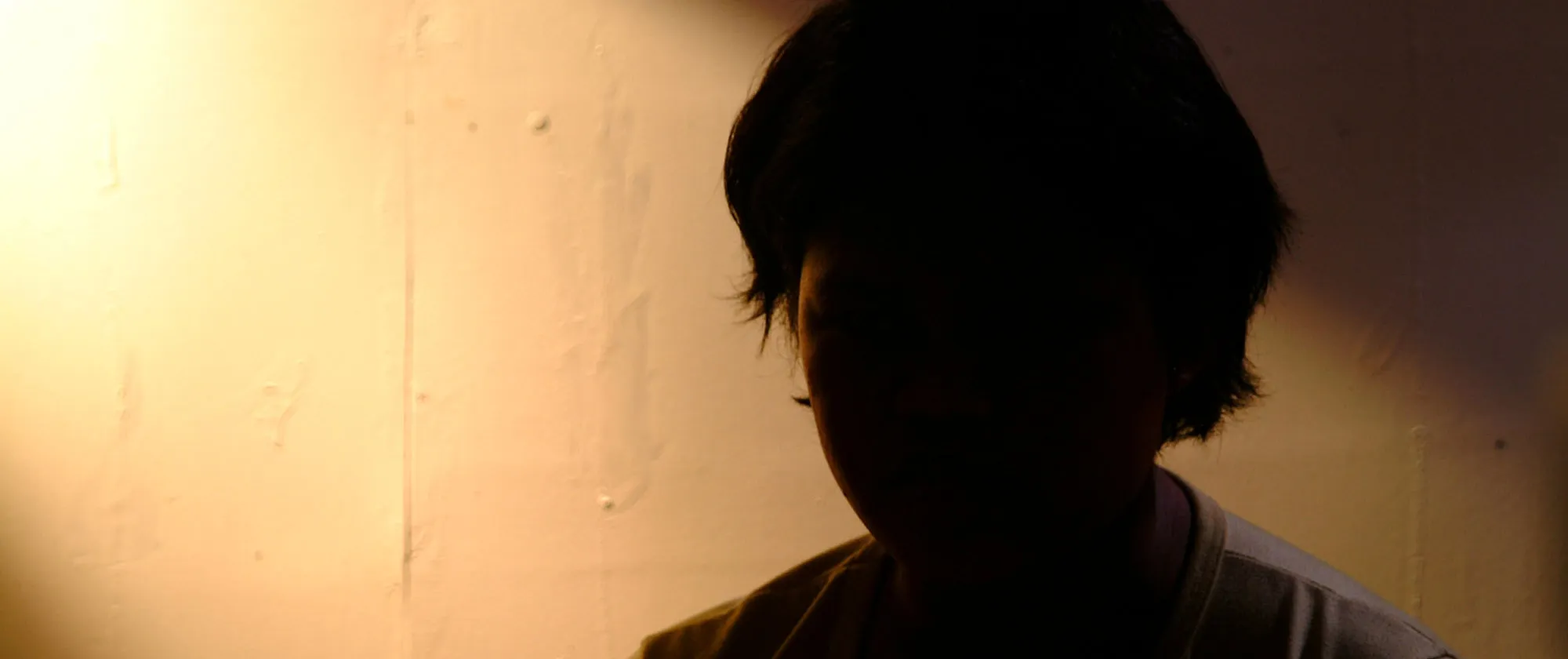 young woman in the dark after experiencing violence and harassment