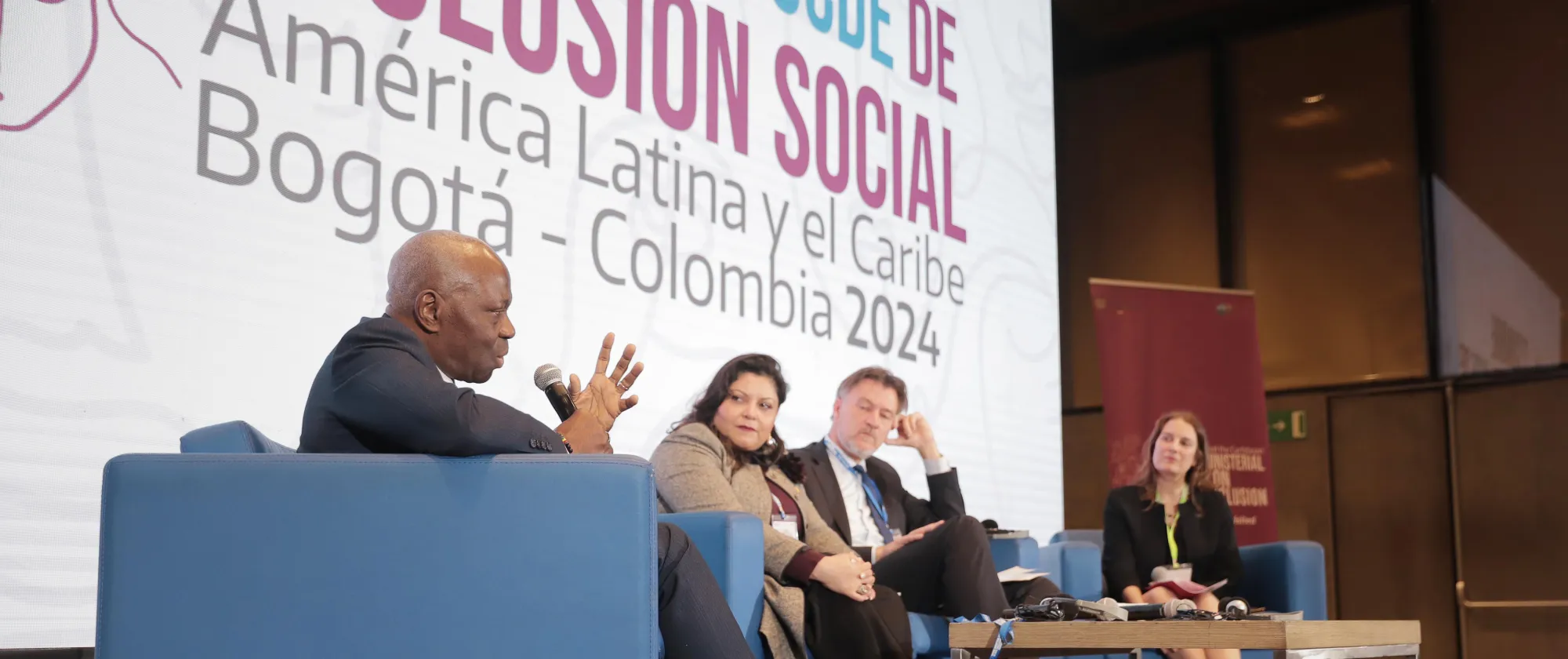 ILO Director-General sits in a panel on the stage