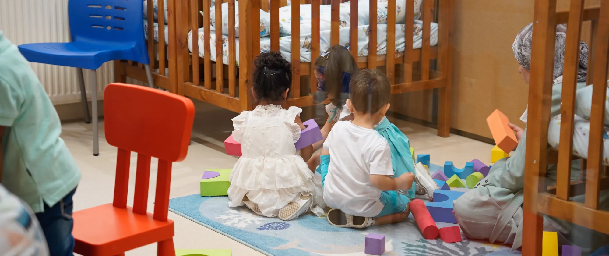 kids playing on the floor in their nursery