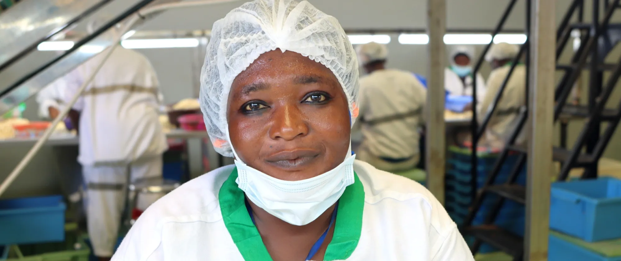 A young woman worker at the EcoCajou factory smiles at the camera. She is a beneficiary of the ILO ProAgro YOUTH project, smiles at the camera in Odienné, Côte d'Ivoire, on 17 September 2024.