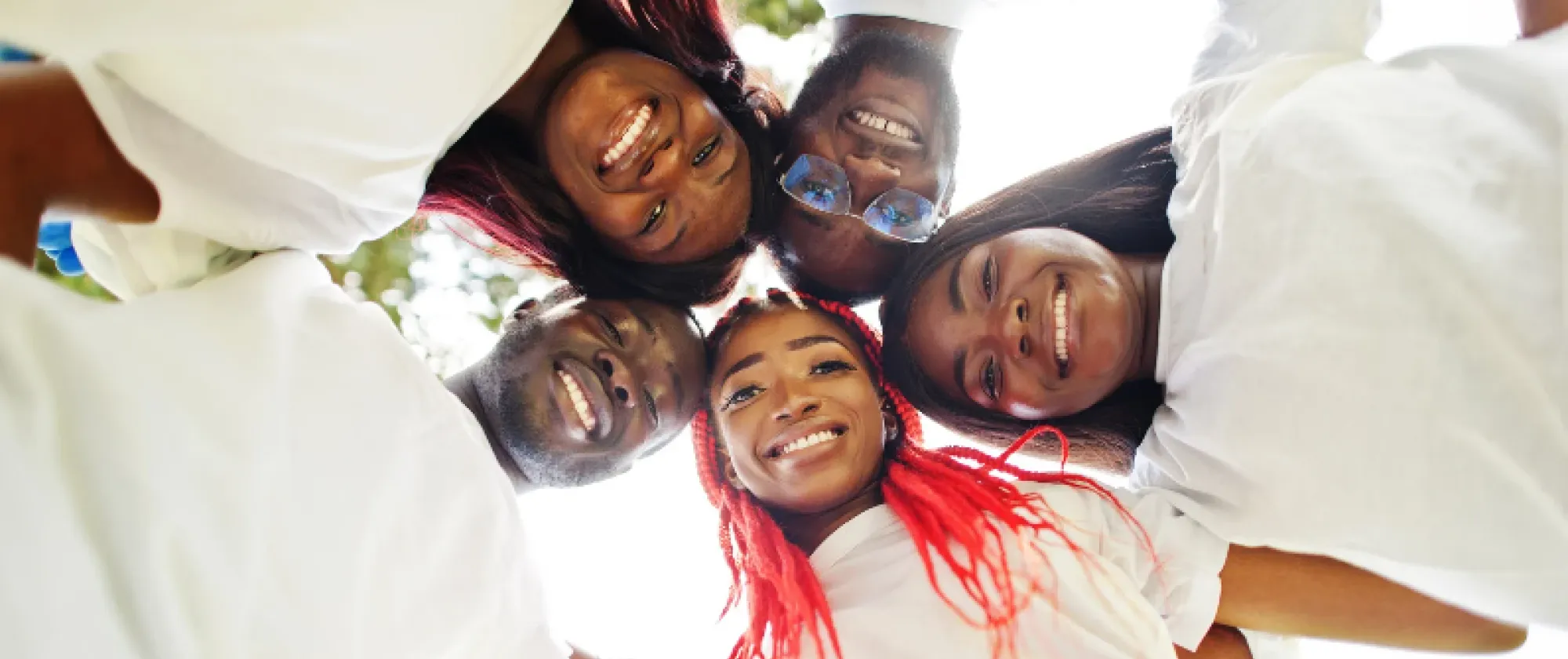 Young people from Africa hug each other and smile