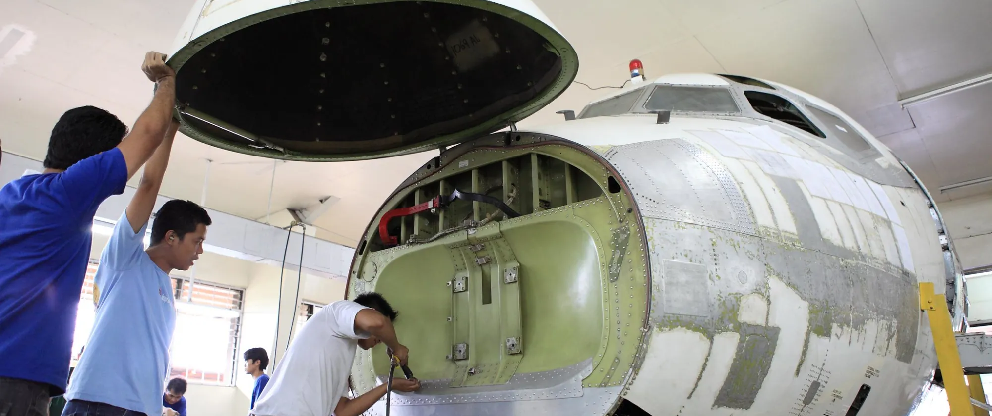 trainees open an aircraft and learn how to repair