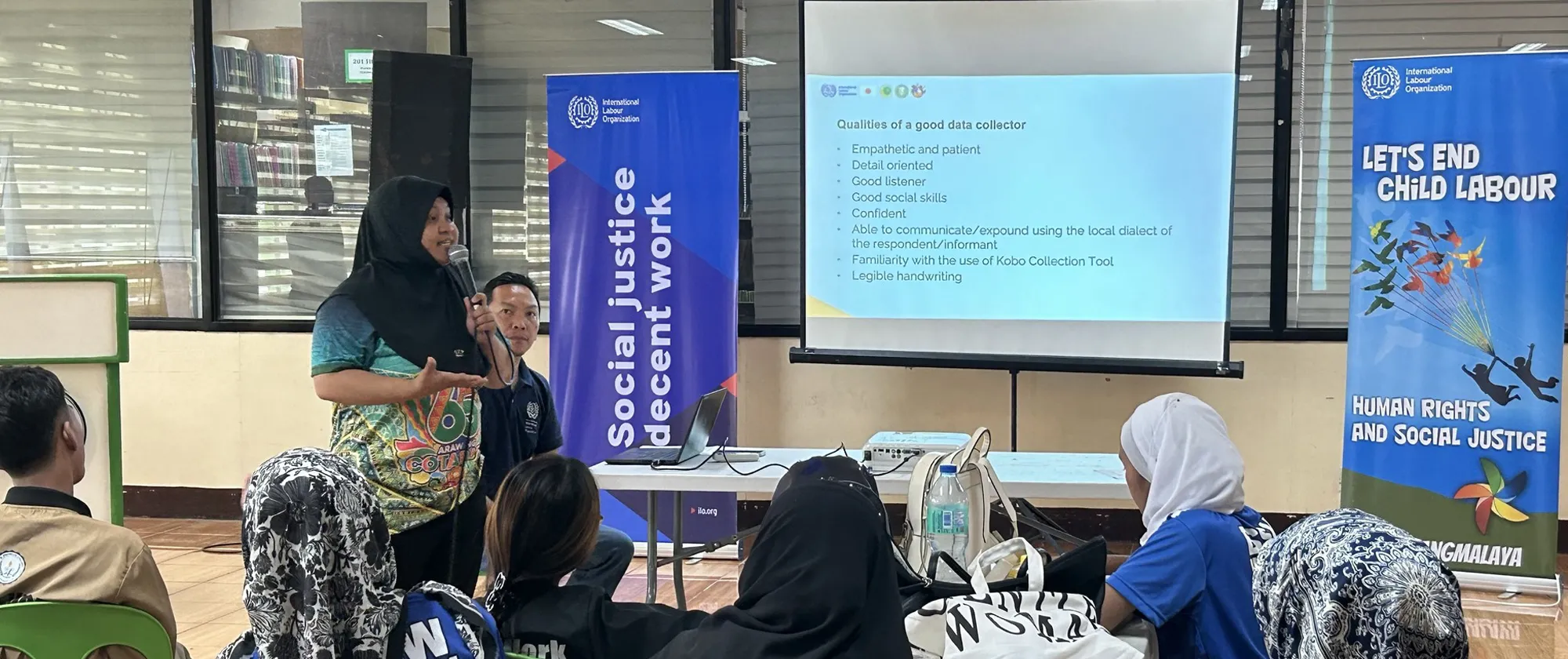 woman in hijab speaking at a child labour digital monitoring workshop