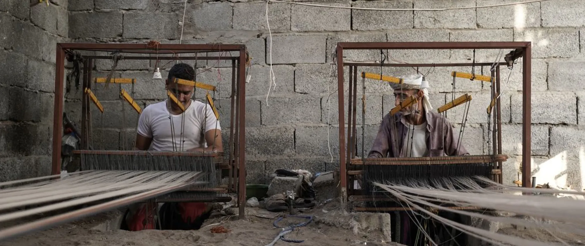 two men working with cloth