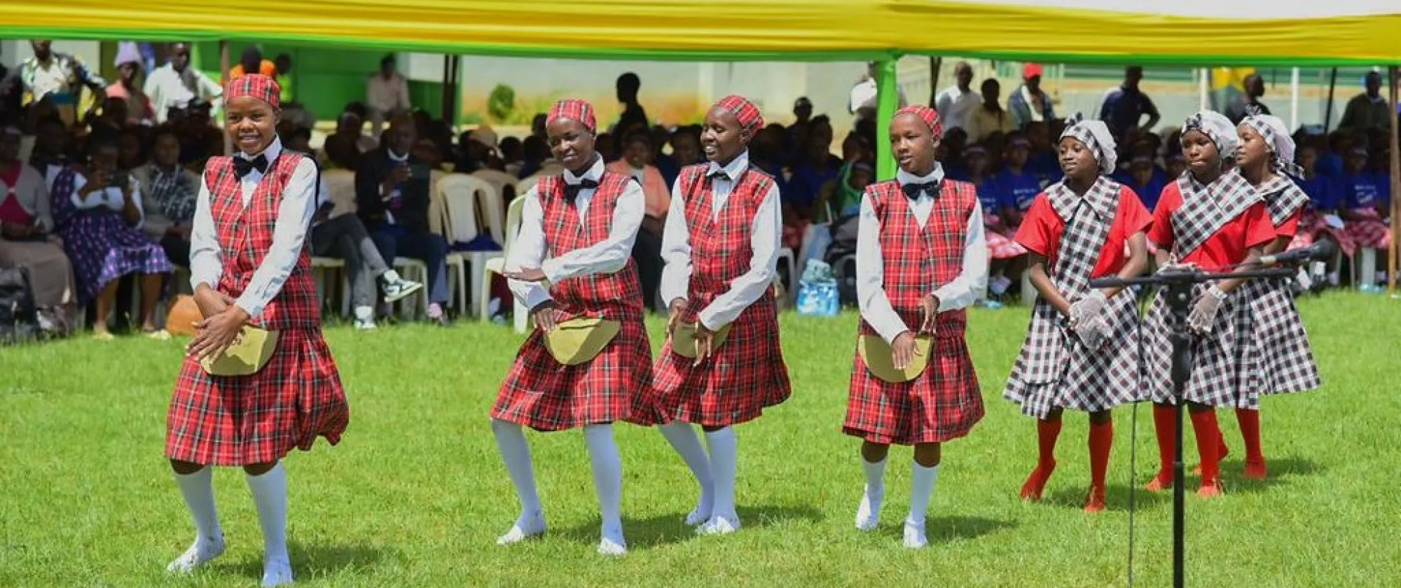 Children dance in a festival with red uniforms