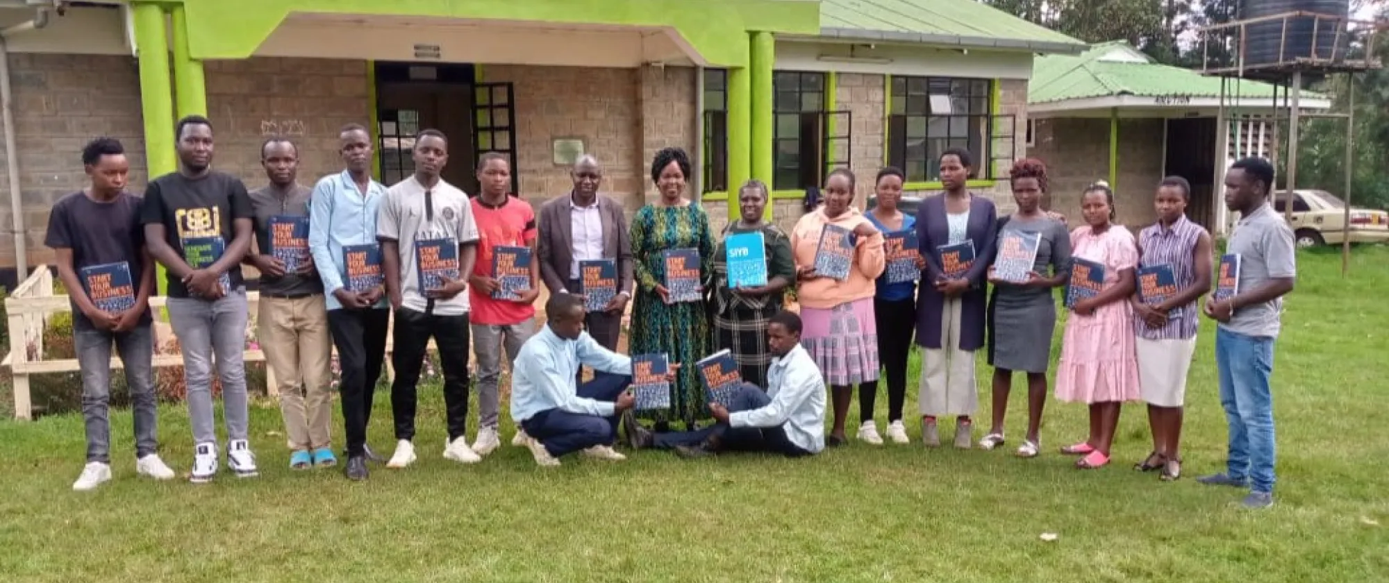 Young people pose for a group picture, young boys are at the left and young girls at the right