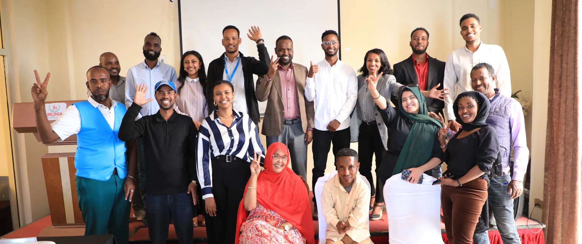 A group of young Ethiopians and ILO partners standing and sitting for a photo