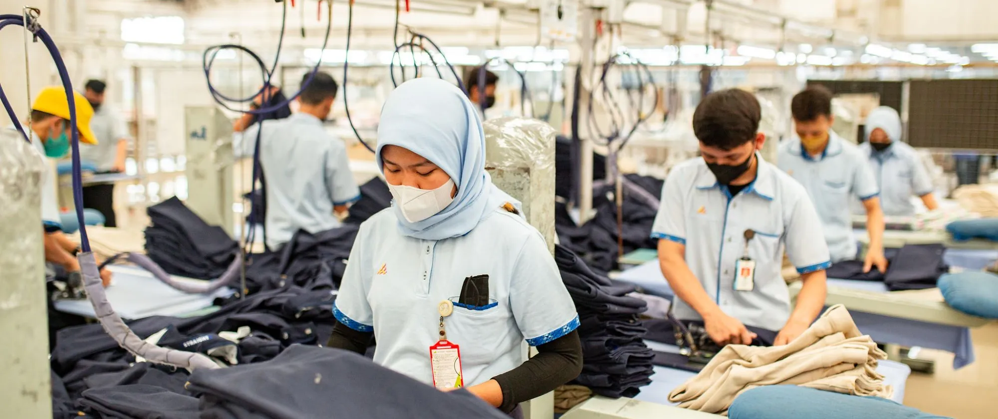 women and men working inside a garment factory in Sukoharjo