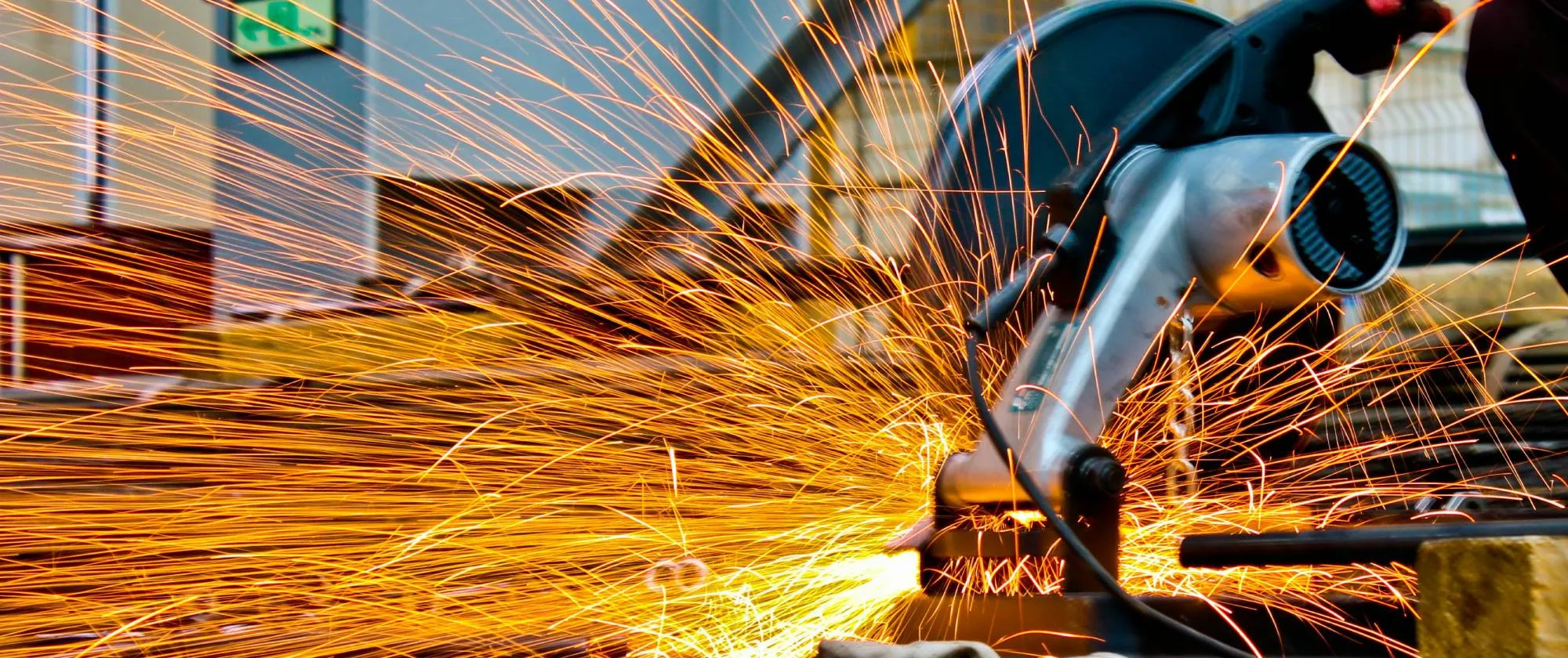 Cut-off saw cutting metal with sparks