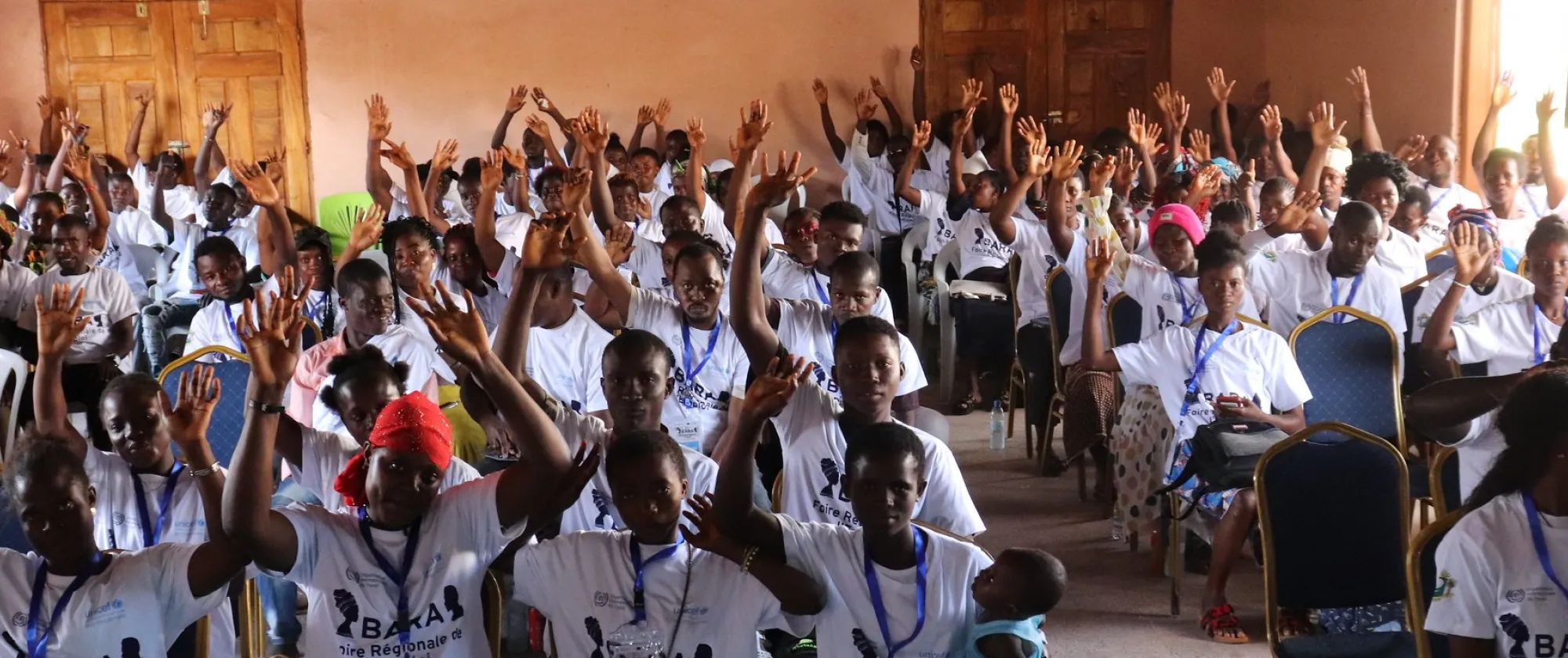 Youth participants to an employment fair raise their hands