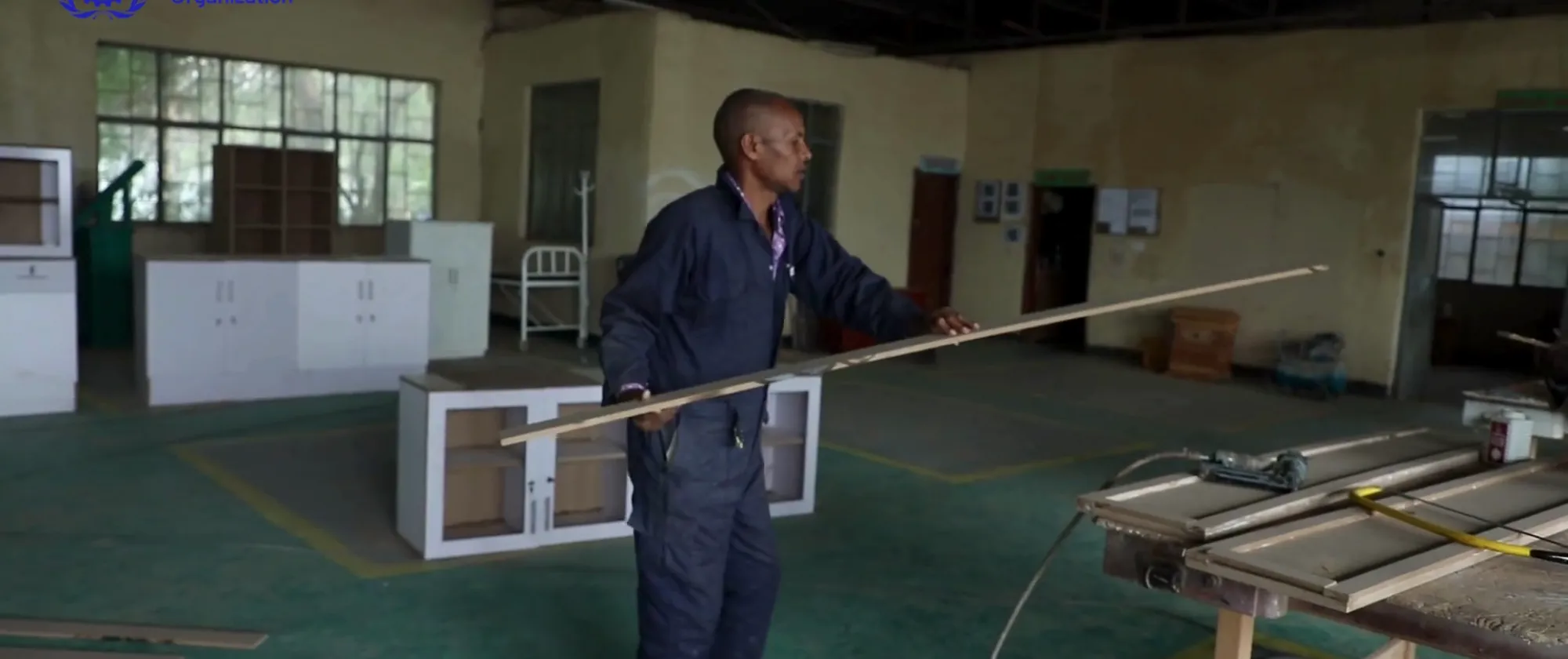 worker carrying wood plank