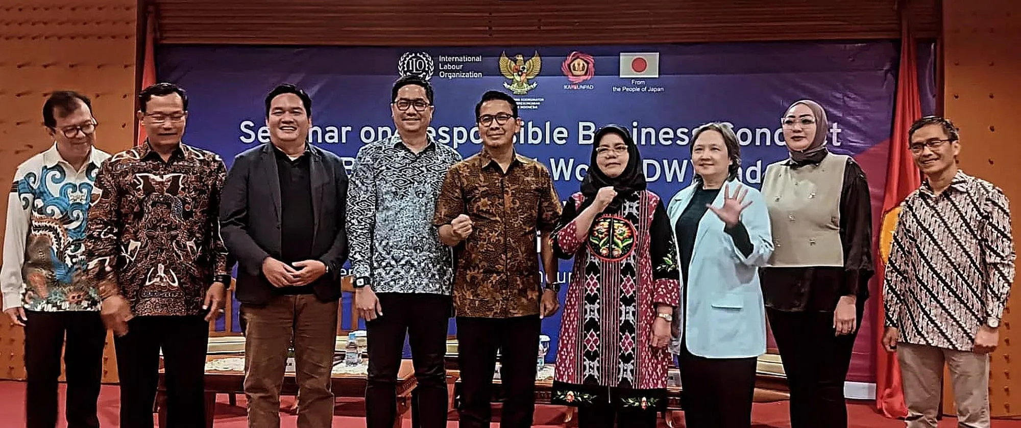 Nine people standing on the stage