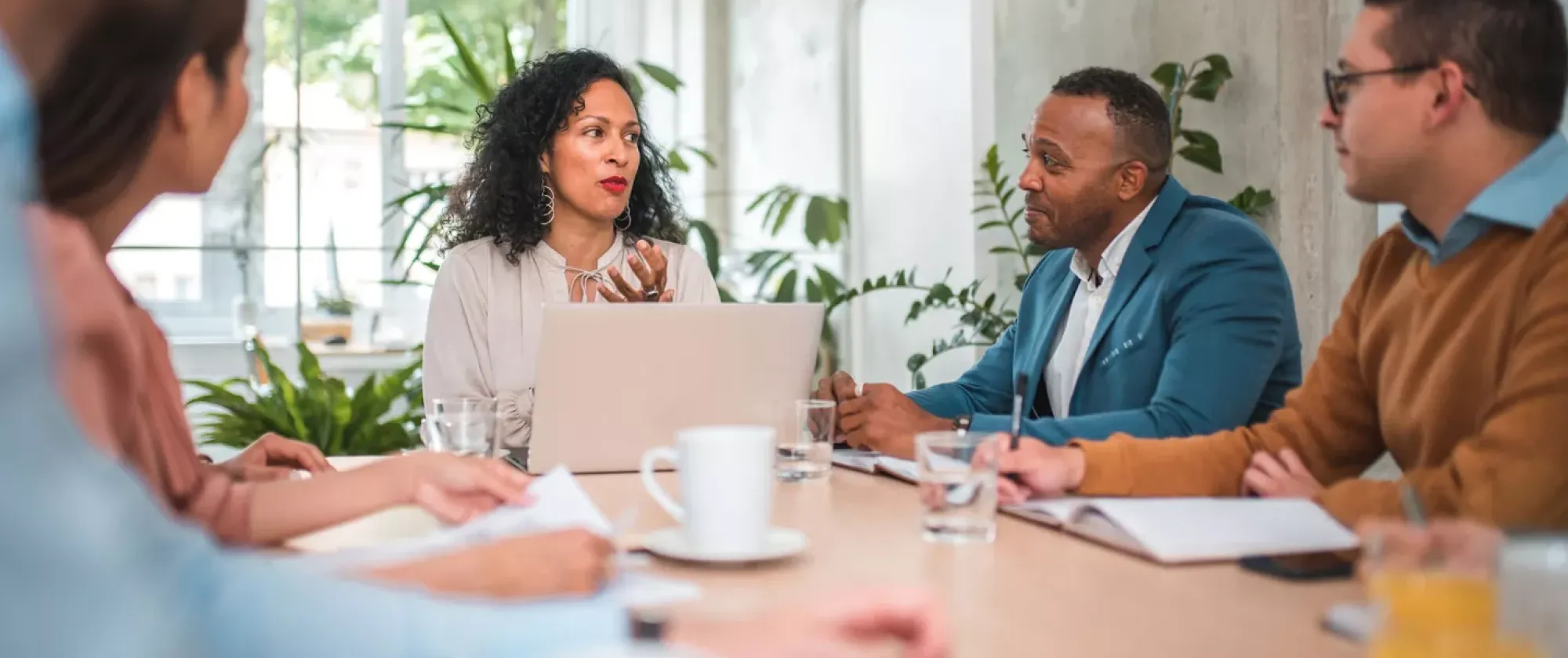Colleagues brainstorming around an office table