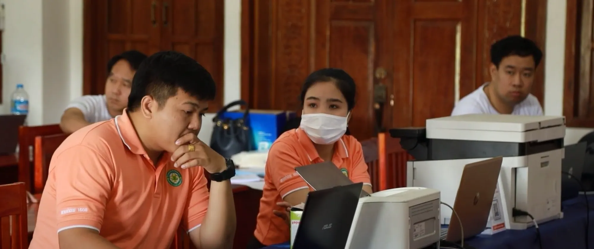 Officials provide social security services to people in rural Lao People's Democratic Republic.