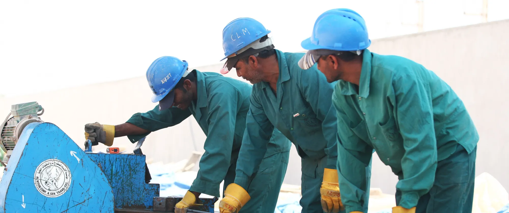 Foreign workers cut steel on a construction site in the UAE, 2021.
