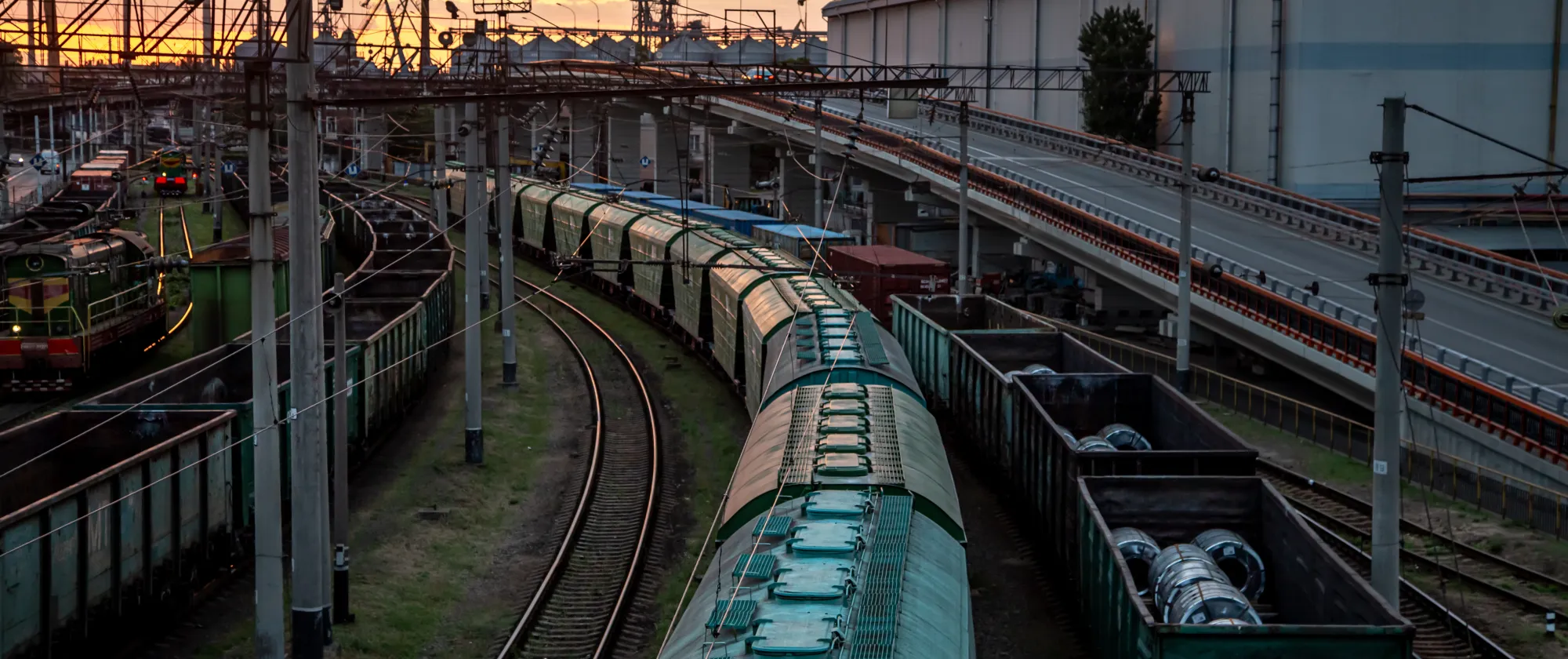View from a railway bridge of freight trains in the sunset