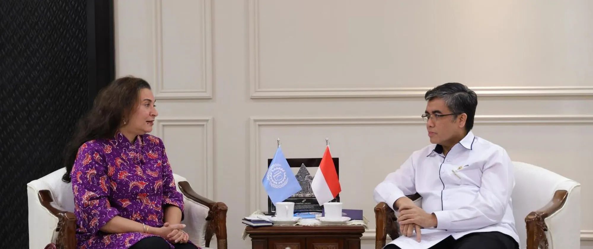 Two people, a female and male, sitting together face to face.
