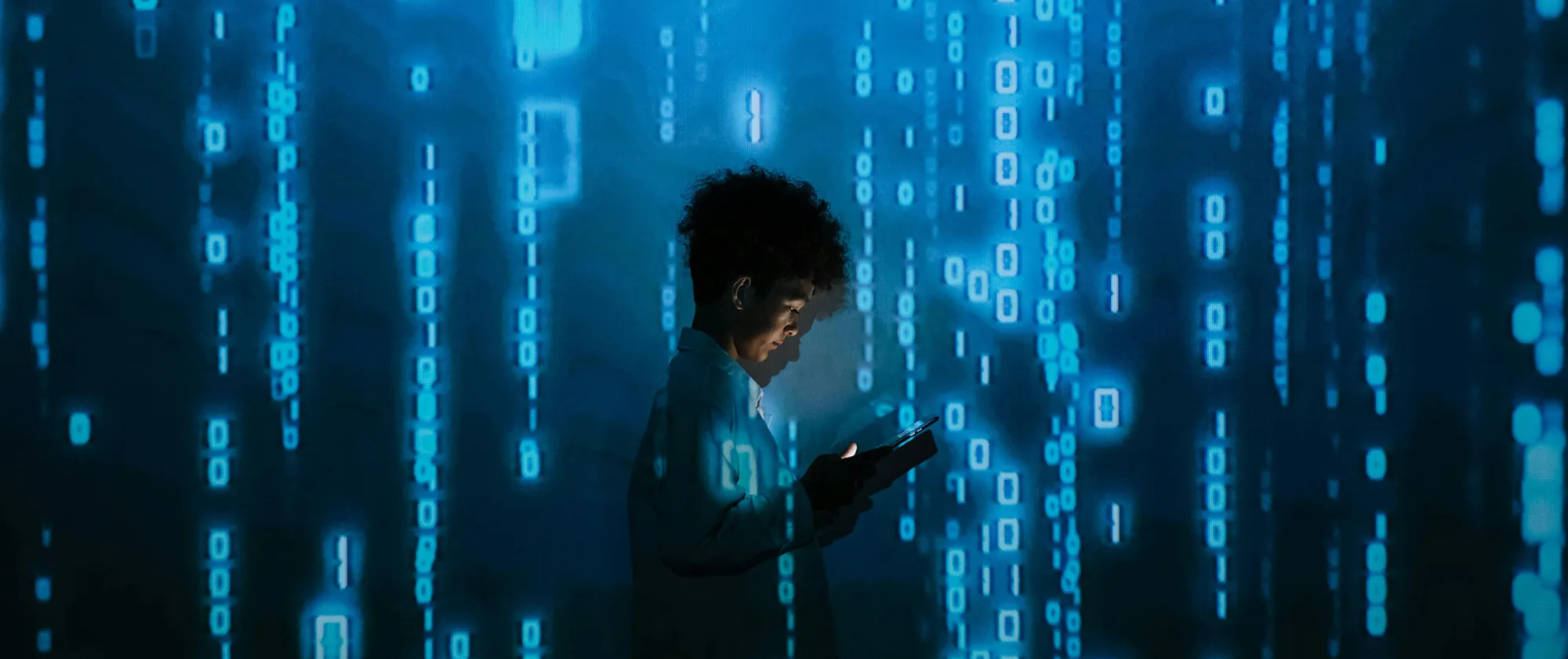 Person with smartphone standing in projection of zeros and ones