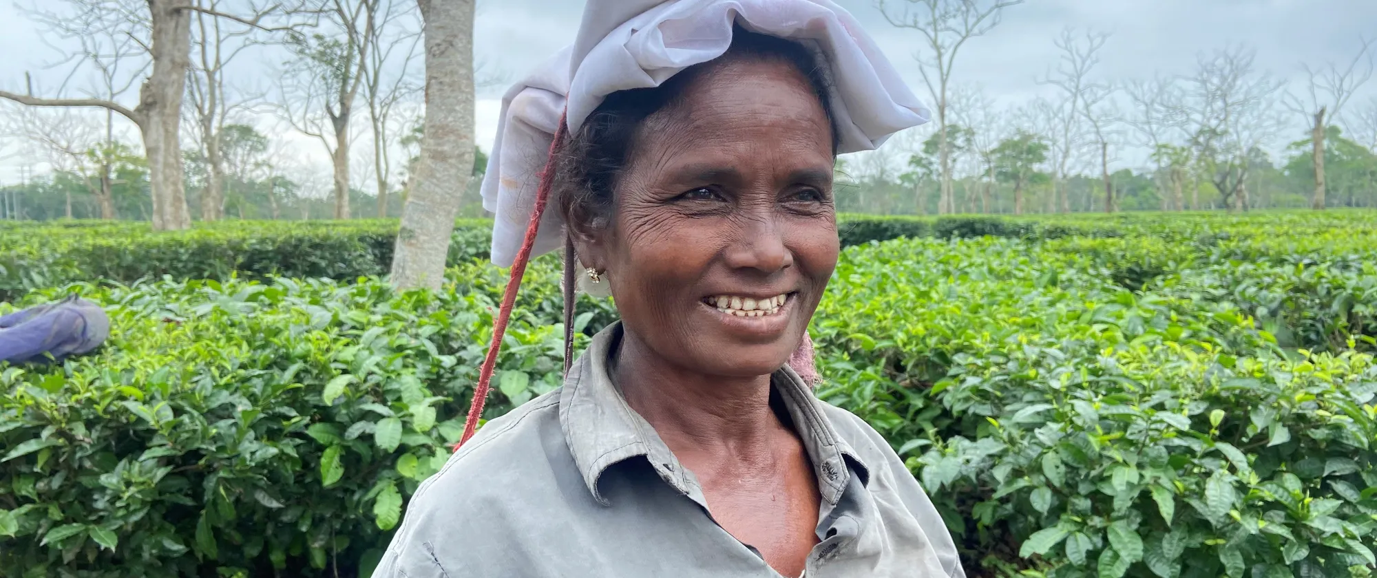 Indian tea picker smiling at the camera