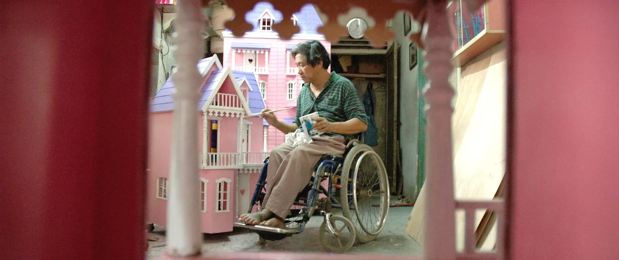 a disabled entrepreneur making pink toy houses