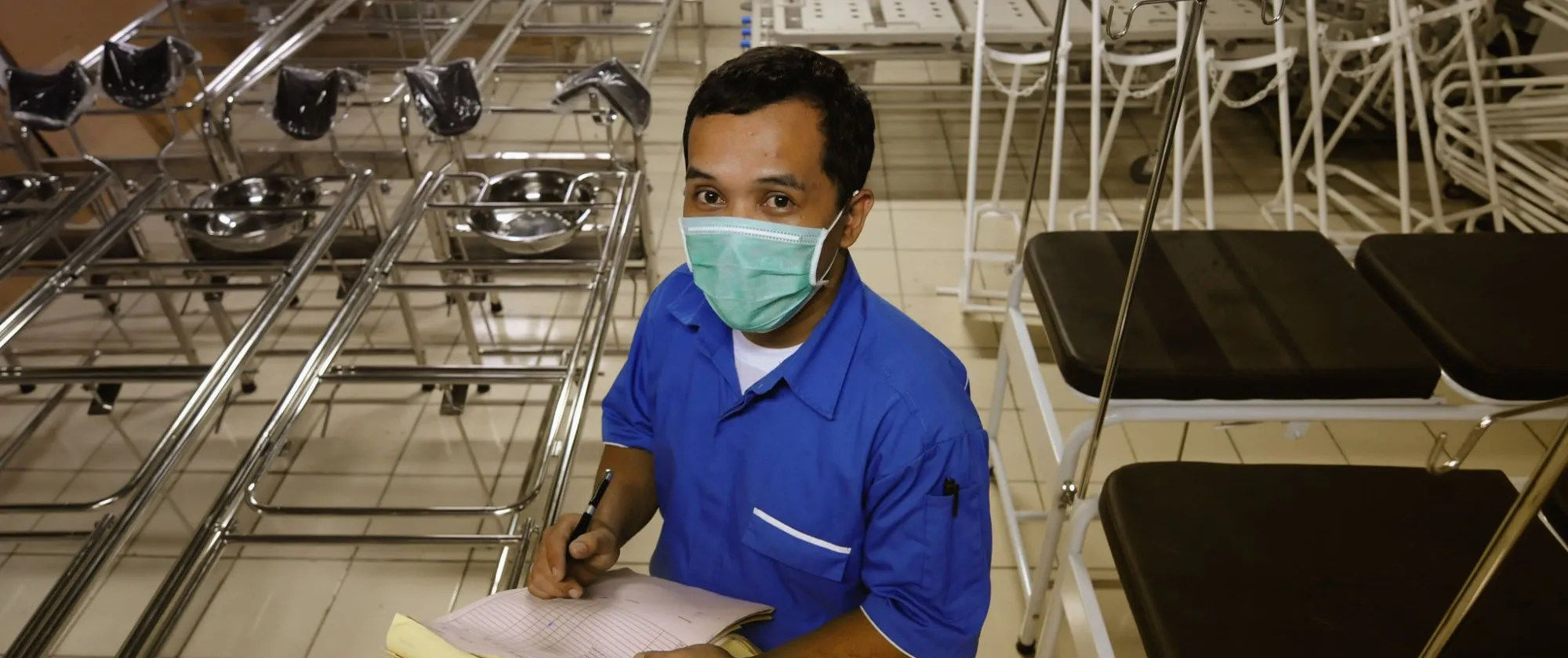 a male worker taking stock of the medical equipment 