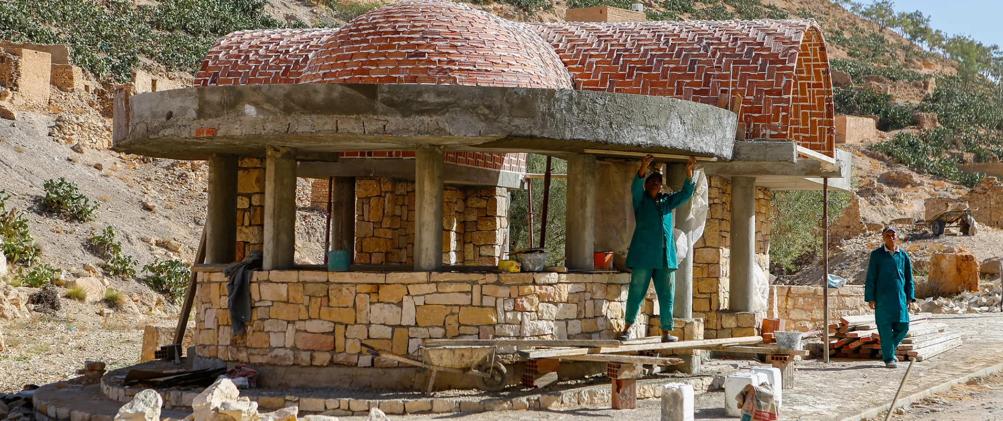 Men working on a traditional stone structure