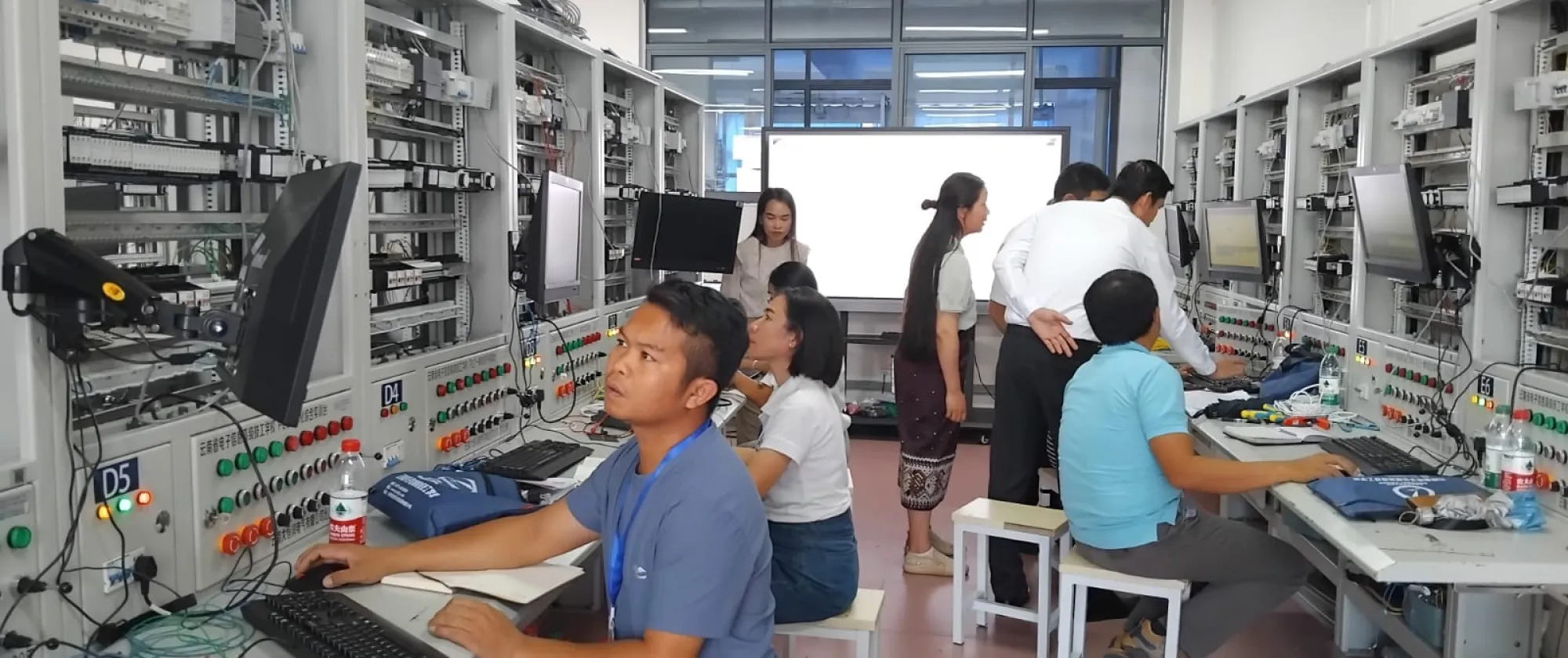 Women and men study electronics.