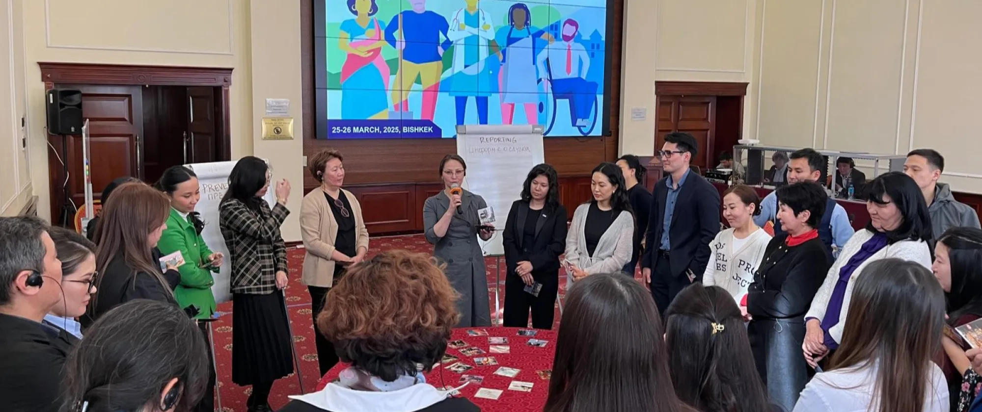 A group of people standing around a table