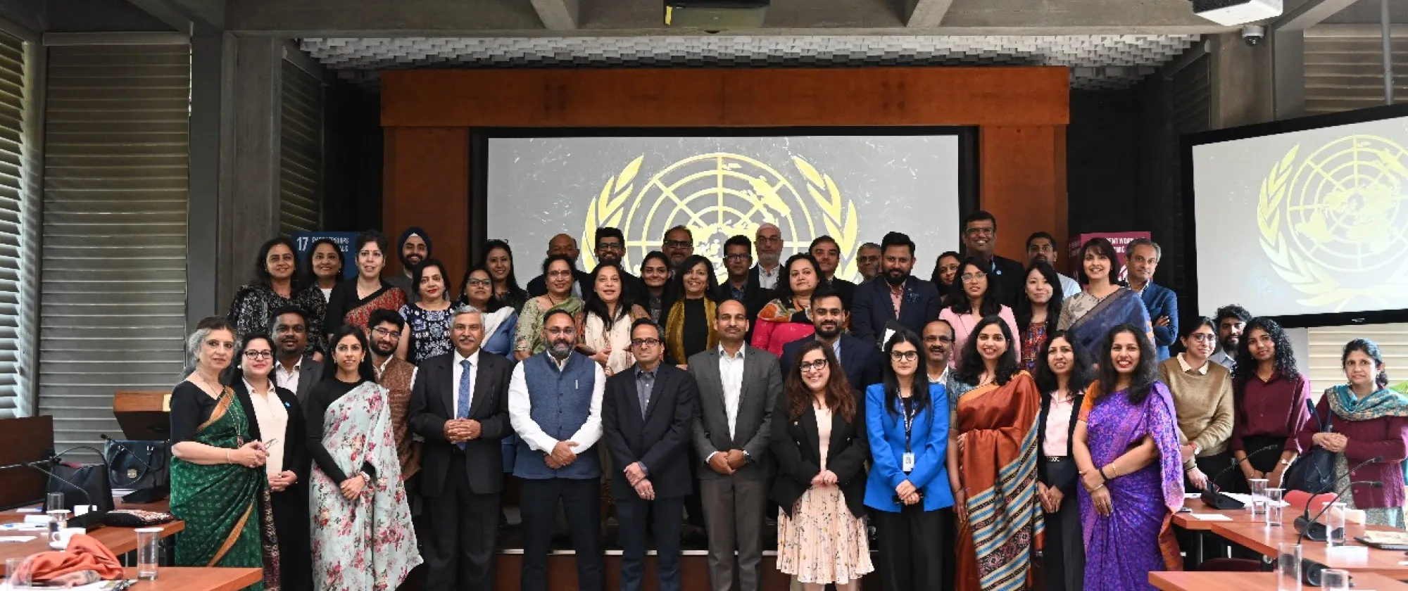 Men and women standing together in a conference room