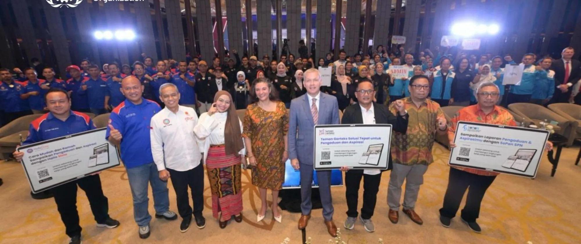 ILOCOJ officials and Canadian ambassador with TU reps holding posters of the grievance apps