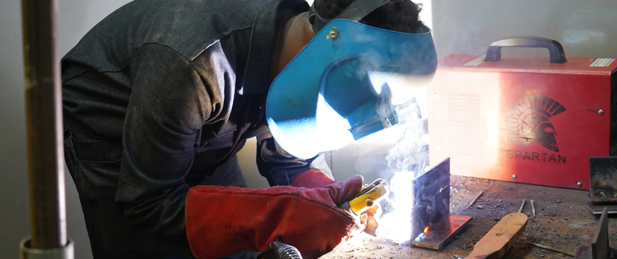 Student welding at the EAIW