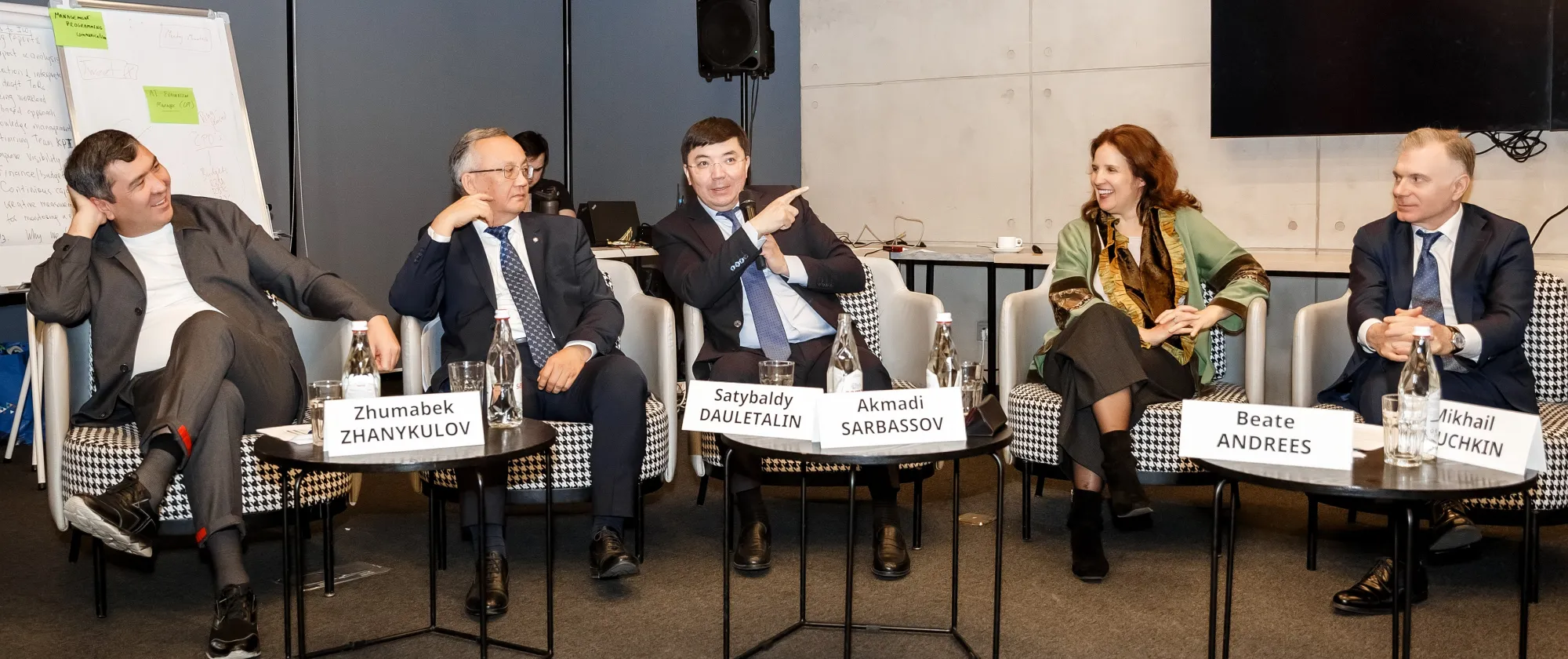 Five panellists sitting in chairs
