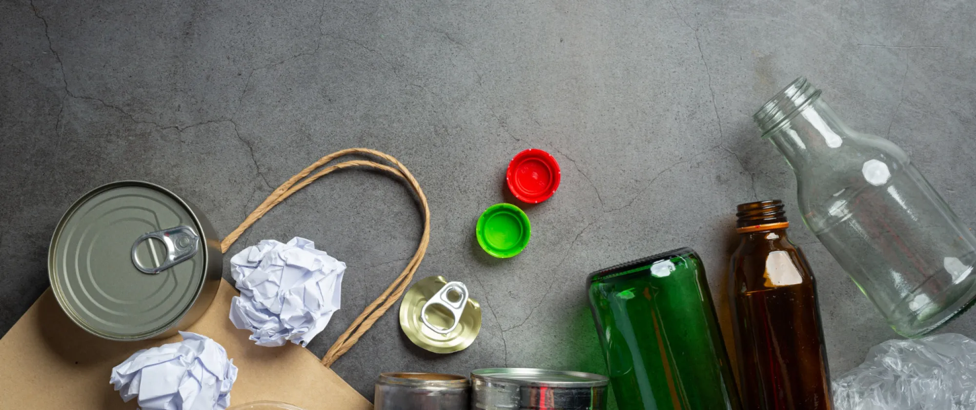 Photo of bottles, tin cans, paper to be recycled