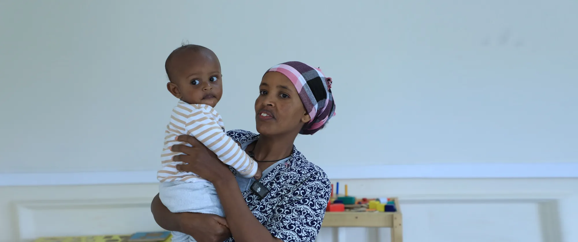 Woinshet, a worker at Yirgalem Addis, holding her baby in a workplace childcare facility for working mothers.