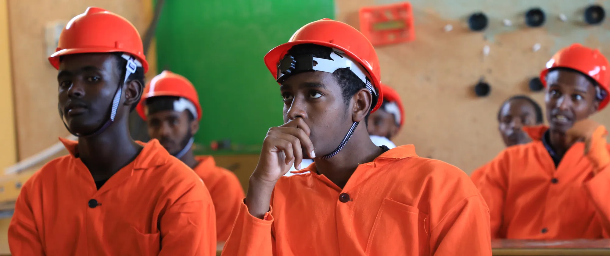 Young men in orange uniform and helmet