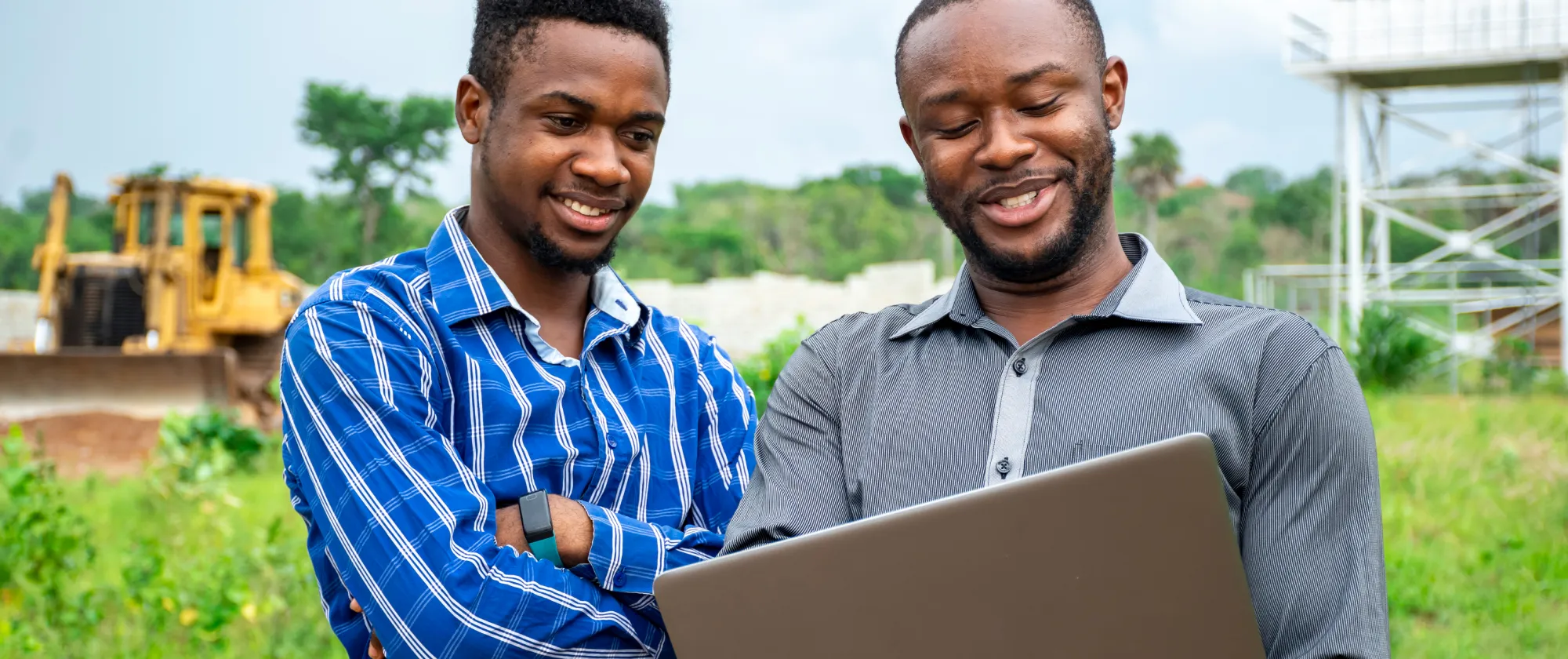 Two men looking at laptop