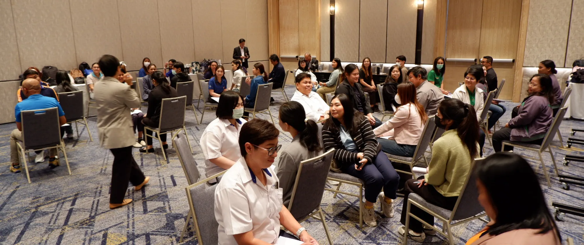Men and women sit facing one another.
