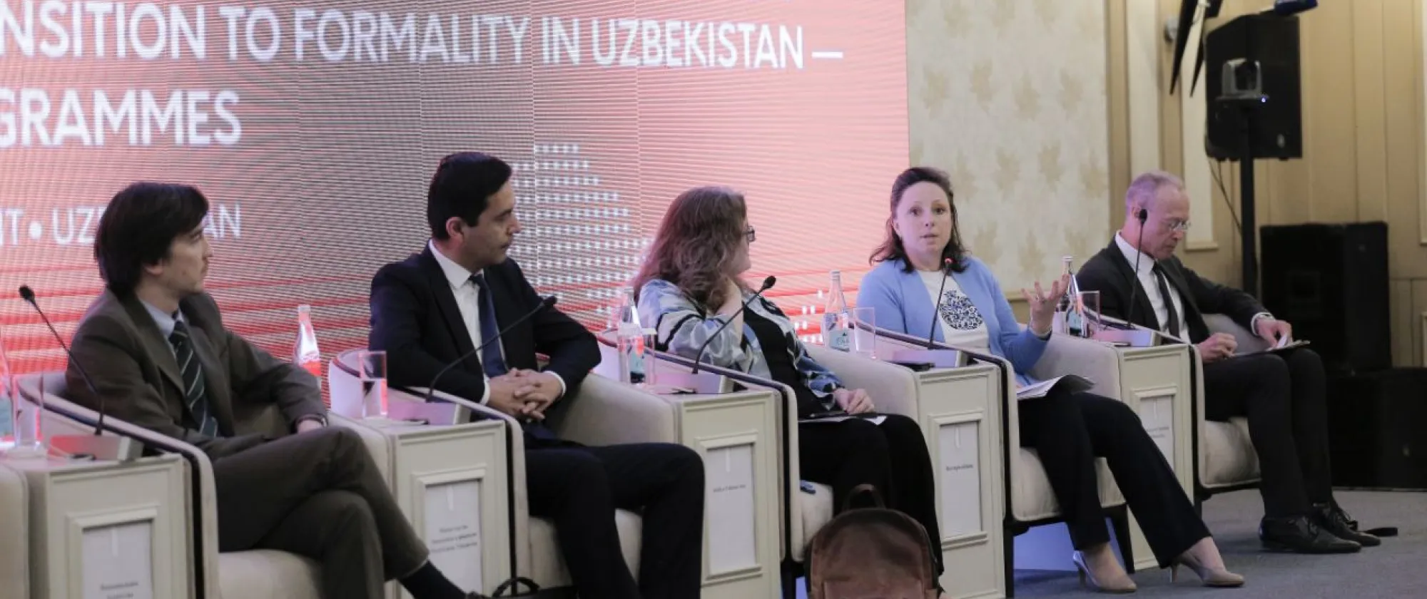 Five people sitting in chair facing the audience