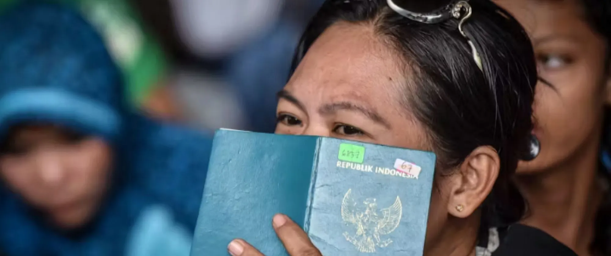 A face of a women covered with a passport