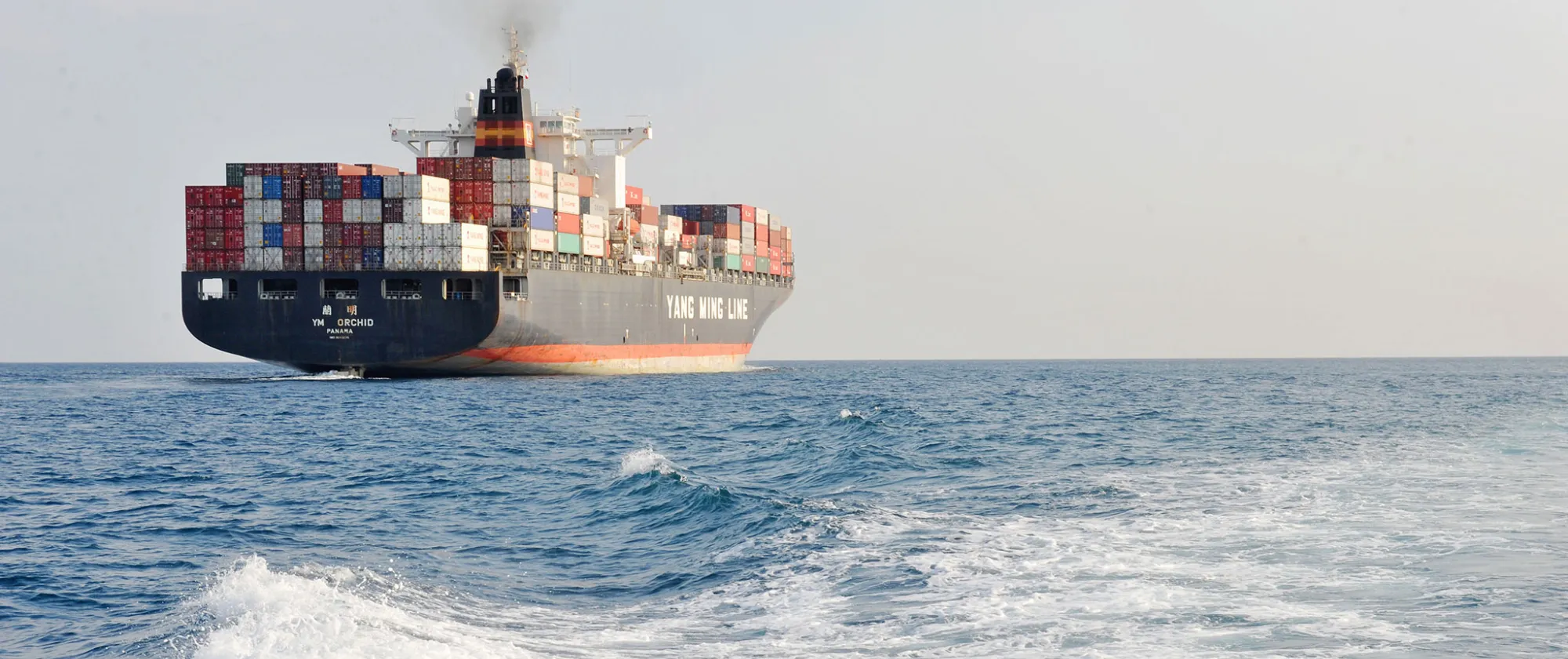 A view of the Chinese ship the "Y M Orchid" leaving the harbour. Port of Genoa, Italy