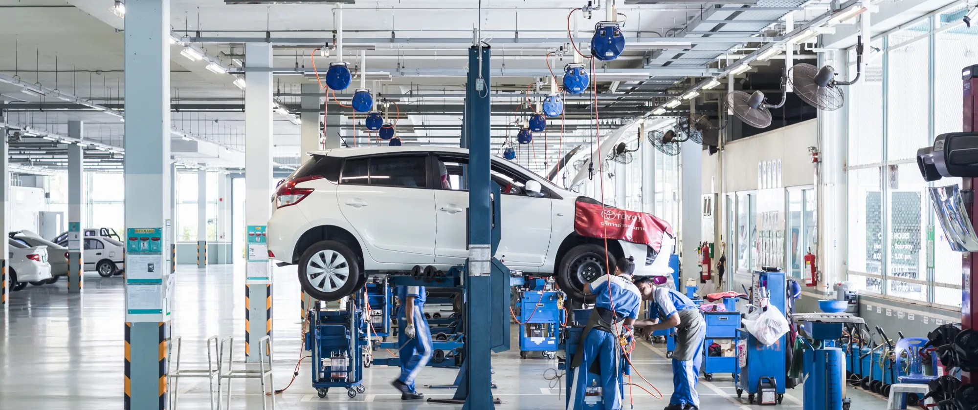 Workers are assembling a car. 