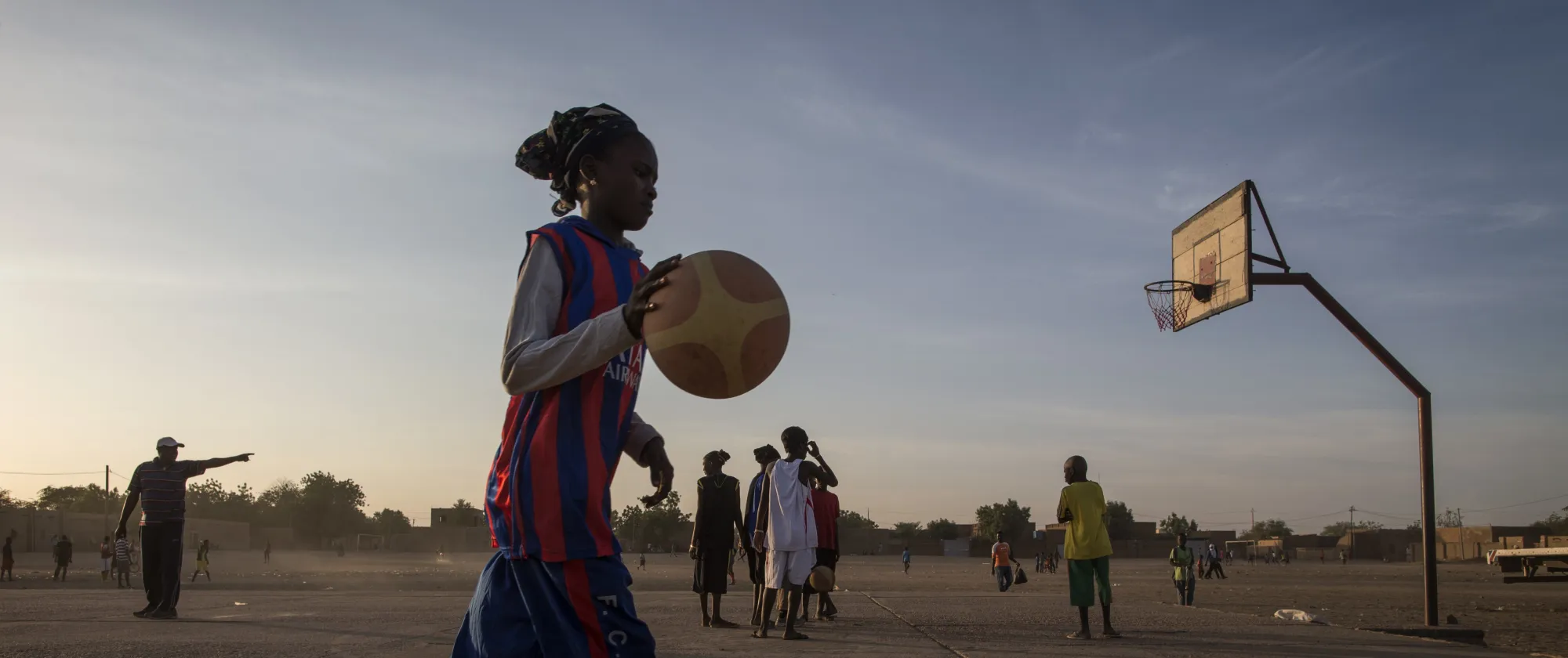 A young girl plays basketball in Gao, Mali in December of 2014. 